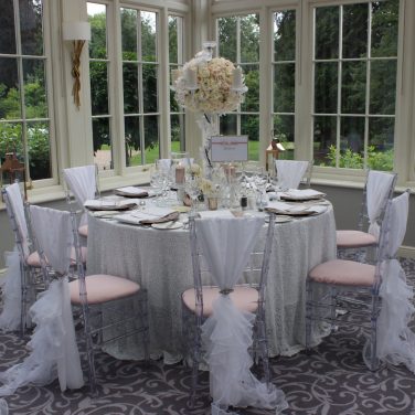 White chiffon chair drape with white ruffle