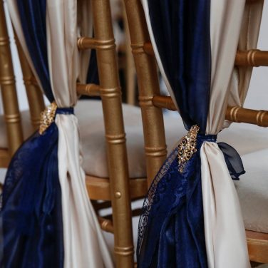 Champagne & navy chair drape with gold barrrettes