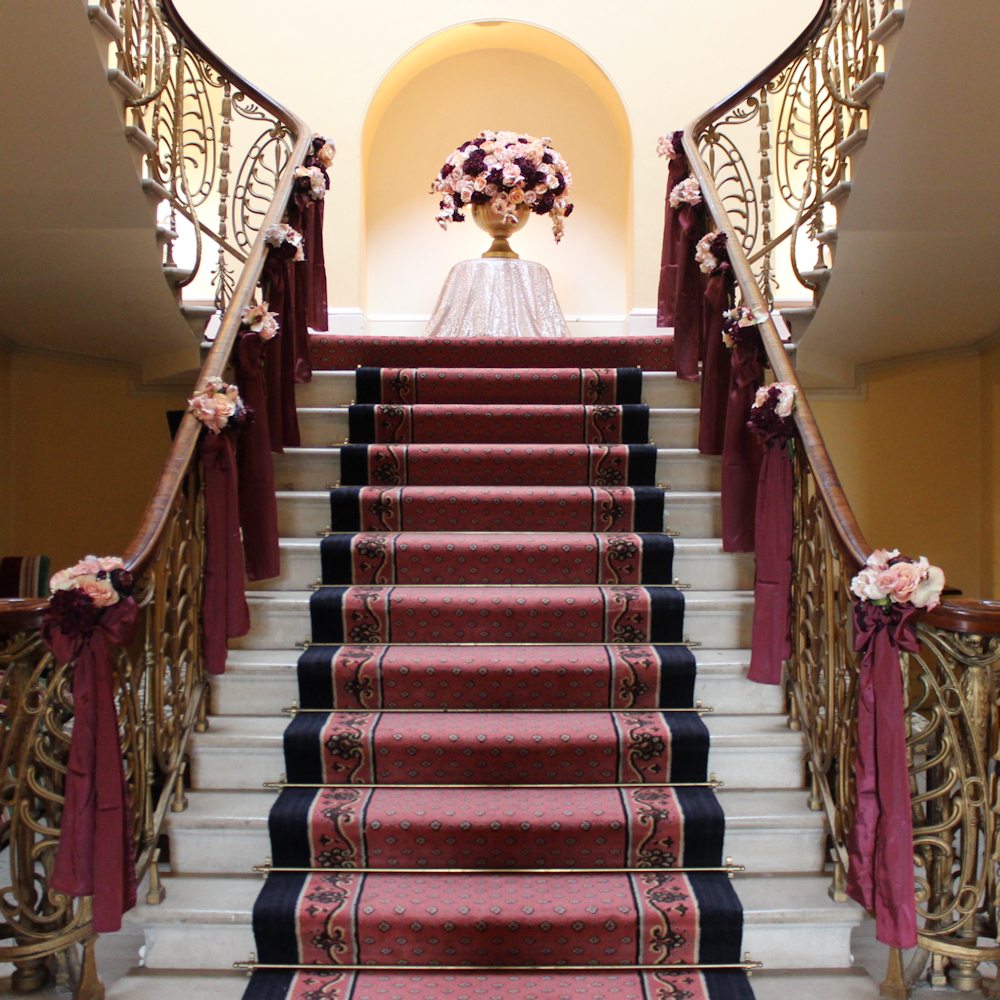 Brocket Hall Main House Stairs with flowers and bows