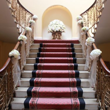 Brocket Hall Main House Stairs with flowers and bows