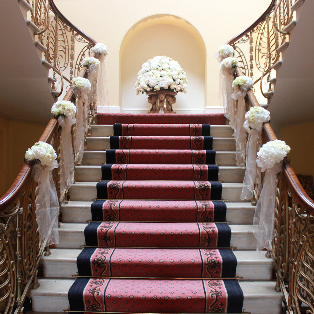 Brocket Hall Main House Stairs with flowers and bows