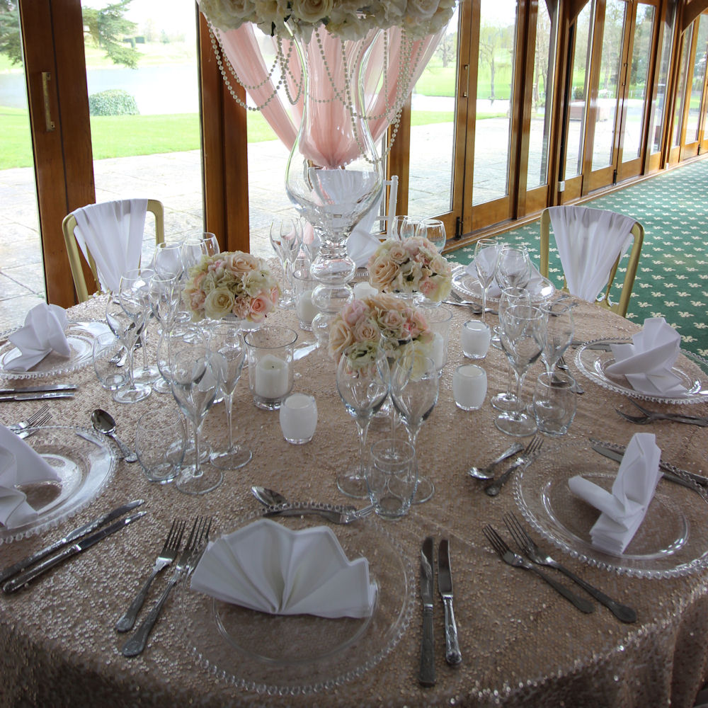 Clear Beaded Charger Plate on Champagne Rose Gold Sequin Tablecloth