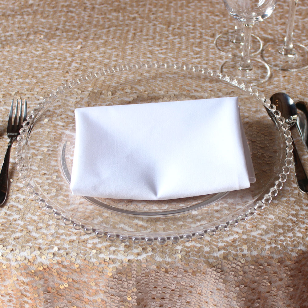 Clear Beaded Charger Plate on Champagne Rose Gold Sequin Tablecloth