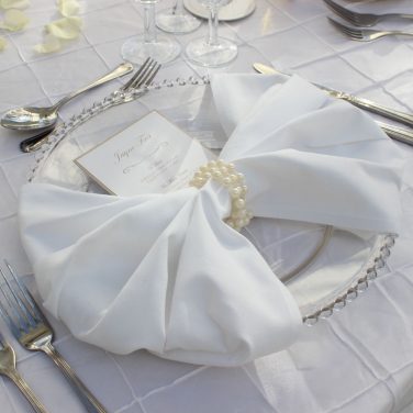 Clear Beaded Charger Plate on White Pin Tuck Tablecloth with Pearls & Fan Napkin