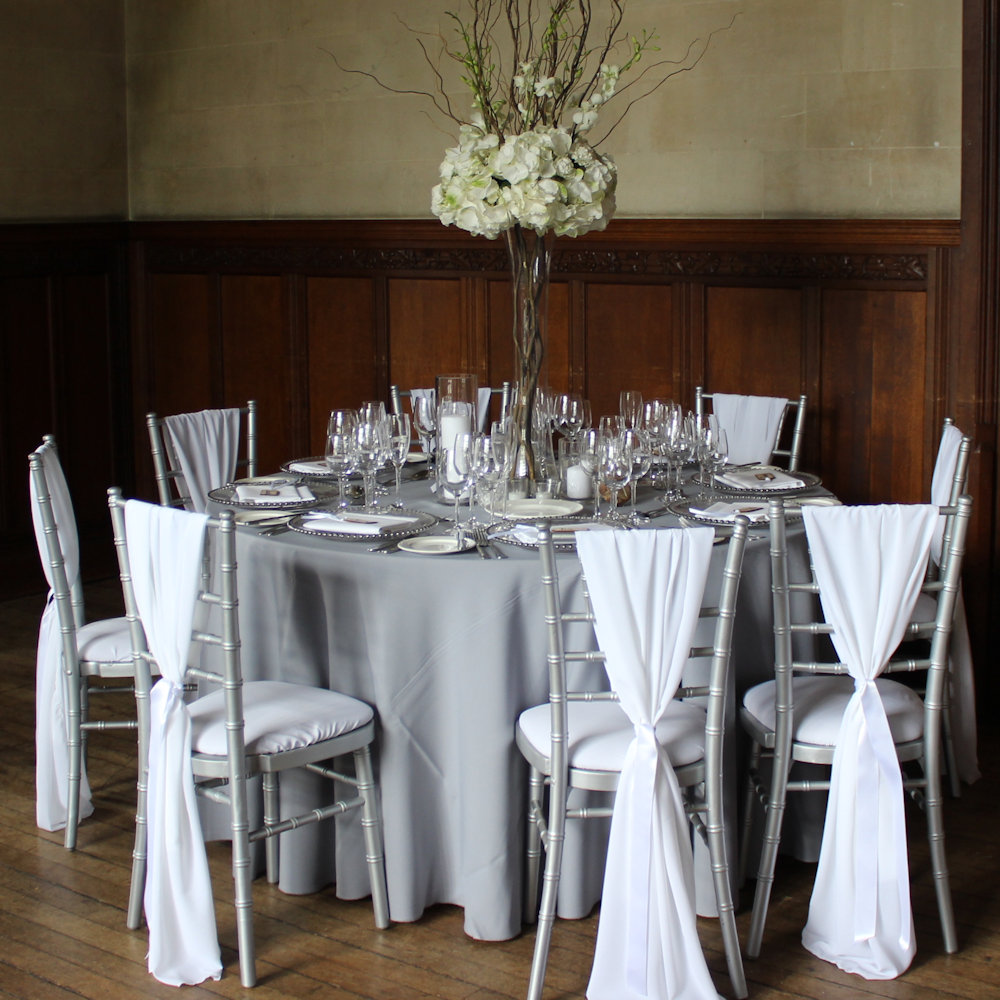 White chiffon drape on silver chiavari chairs