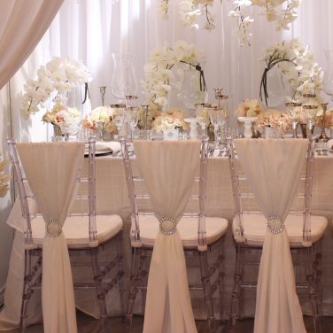 Ice ghost chairs with White Chiffon Drapes