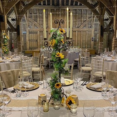 Rustic candleabra with sunflower garland at priory