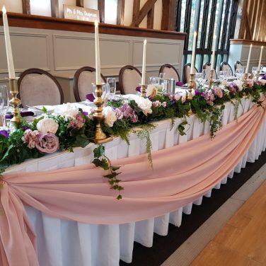 Essendon Top table foliage garland lilac blush swag flowers pleated tablecloth gold candle sticks led candles