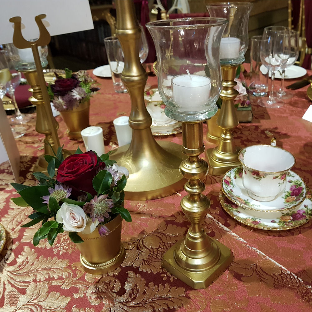 Beauty and the beast gold candlesticks & red damask tablecloth