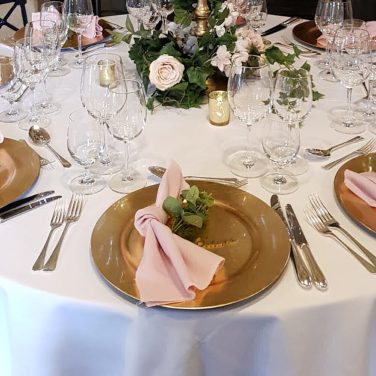 Gold candleabra with blush flowers foliage garland gold charger plates napkins