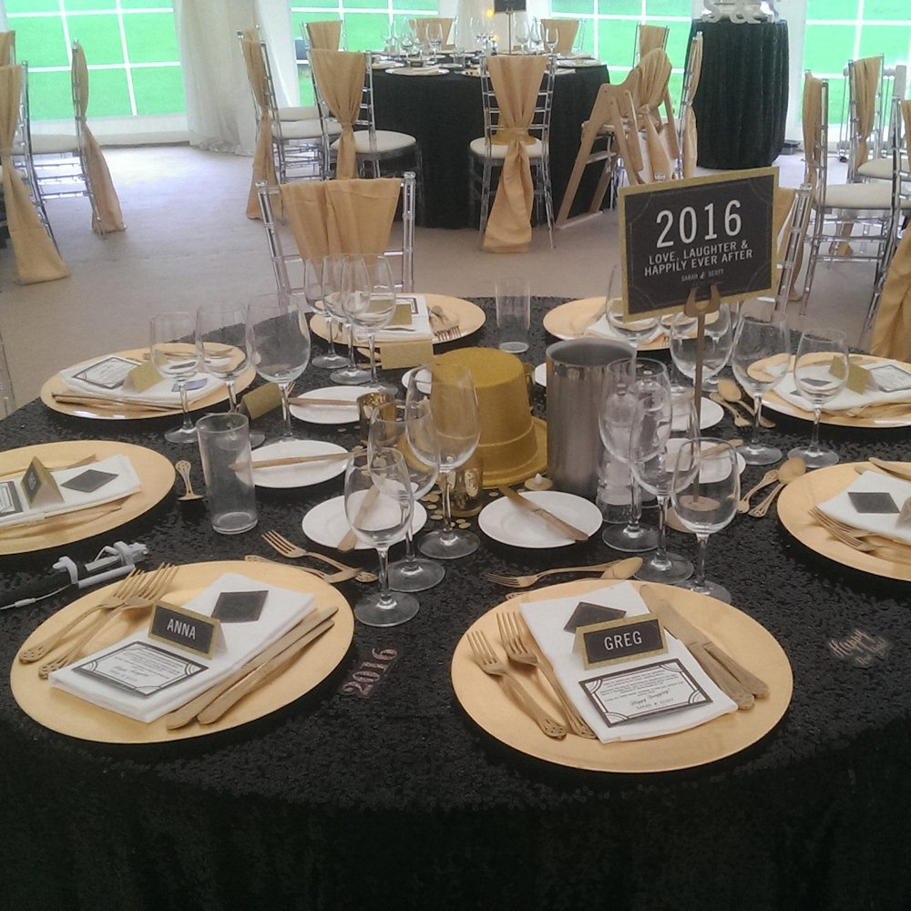 Black sequin tablecloths gold satin vertical drapes & ghost chiavari