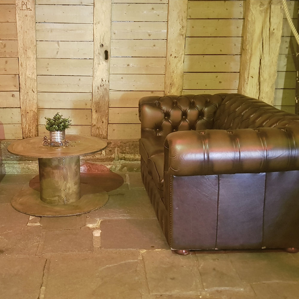 Rustic brown chesterfield sofas cable drum coffee table priory