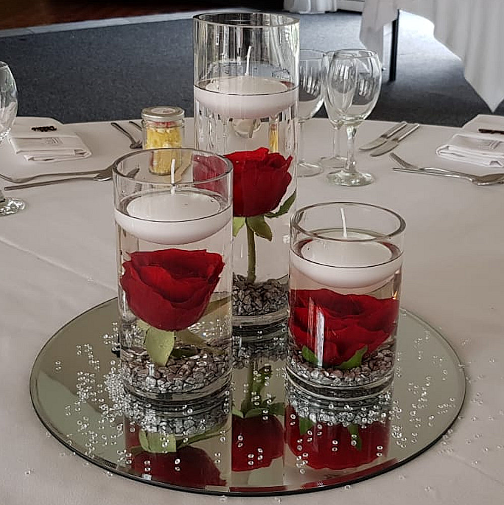 Mirror cylinder vases with red roses andwhite floating candles (1)