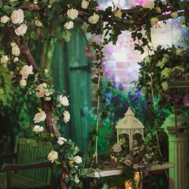Branch Stick Arch with rose garland and swing