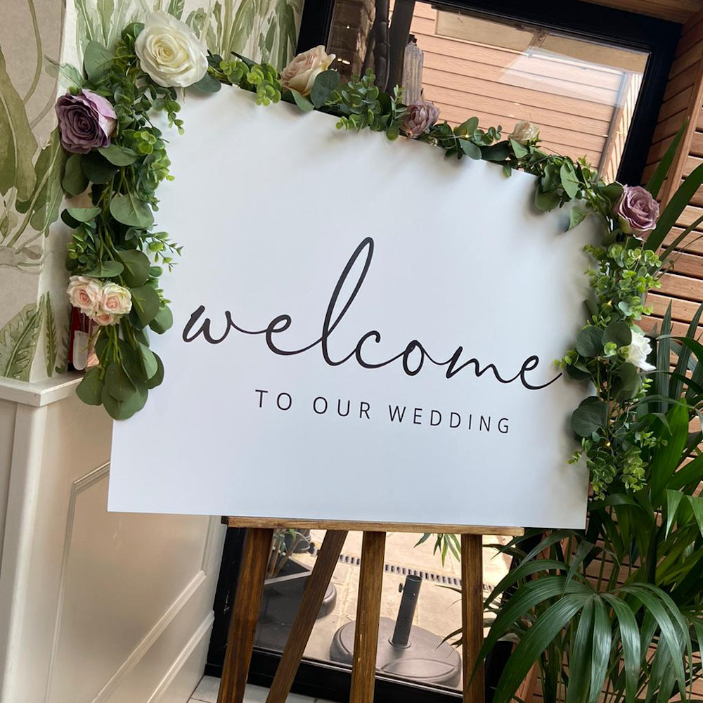 White Welcome Sign with Rustic Easle