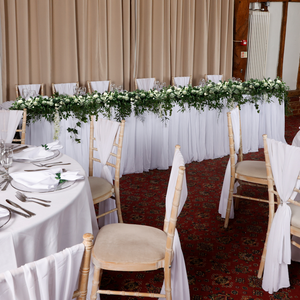 Top Table with messy flower runner Knebworth barns