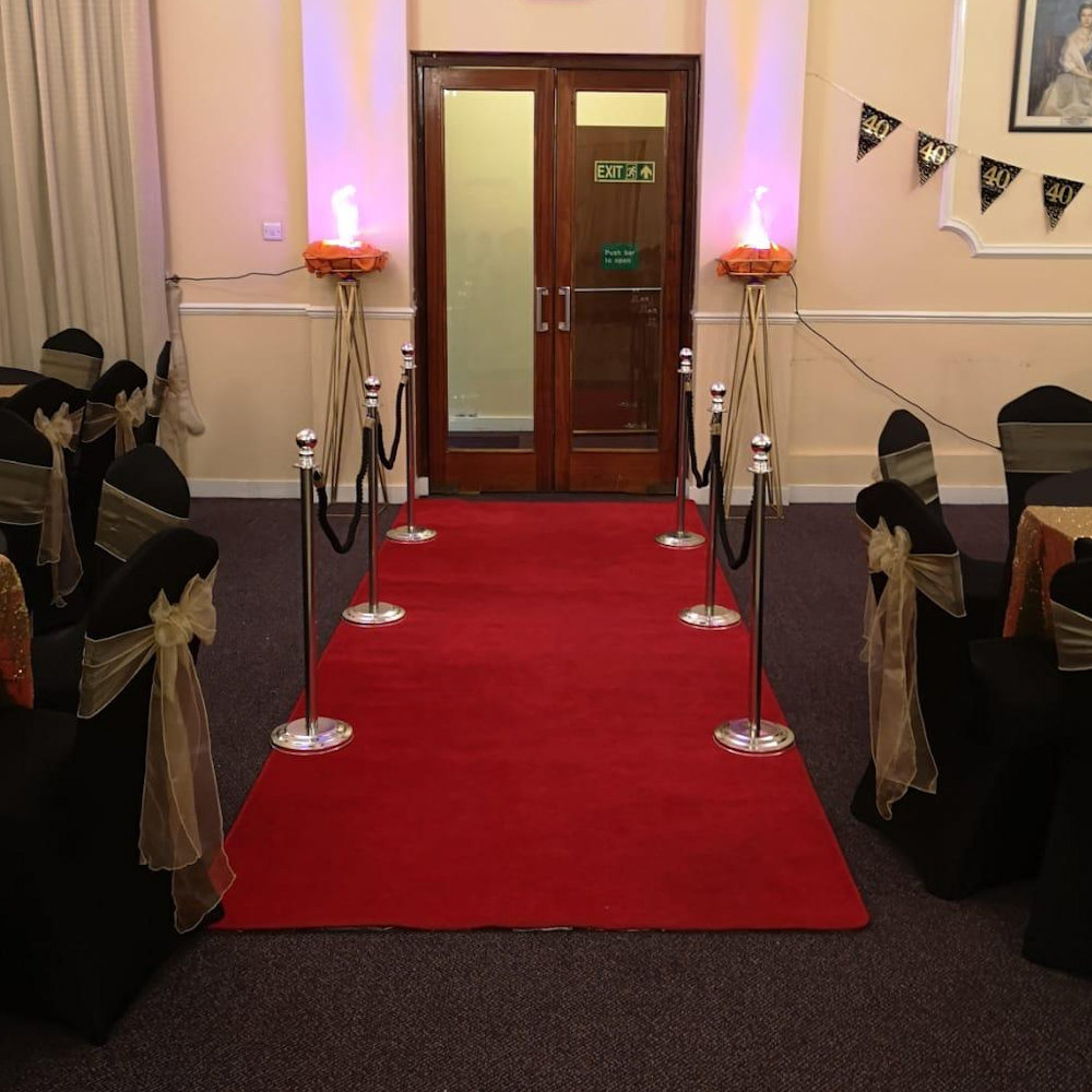 Flame Lights on geometric stands Red carpet, rope and pole at gatsby party