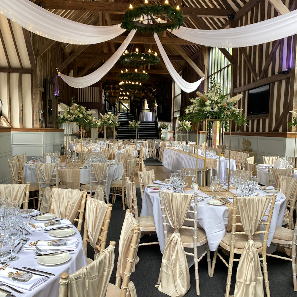 Champagne chair wraps with rectangular stands and cheesecloth runners (1)