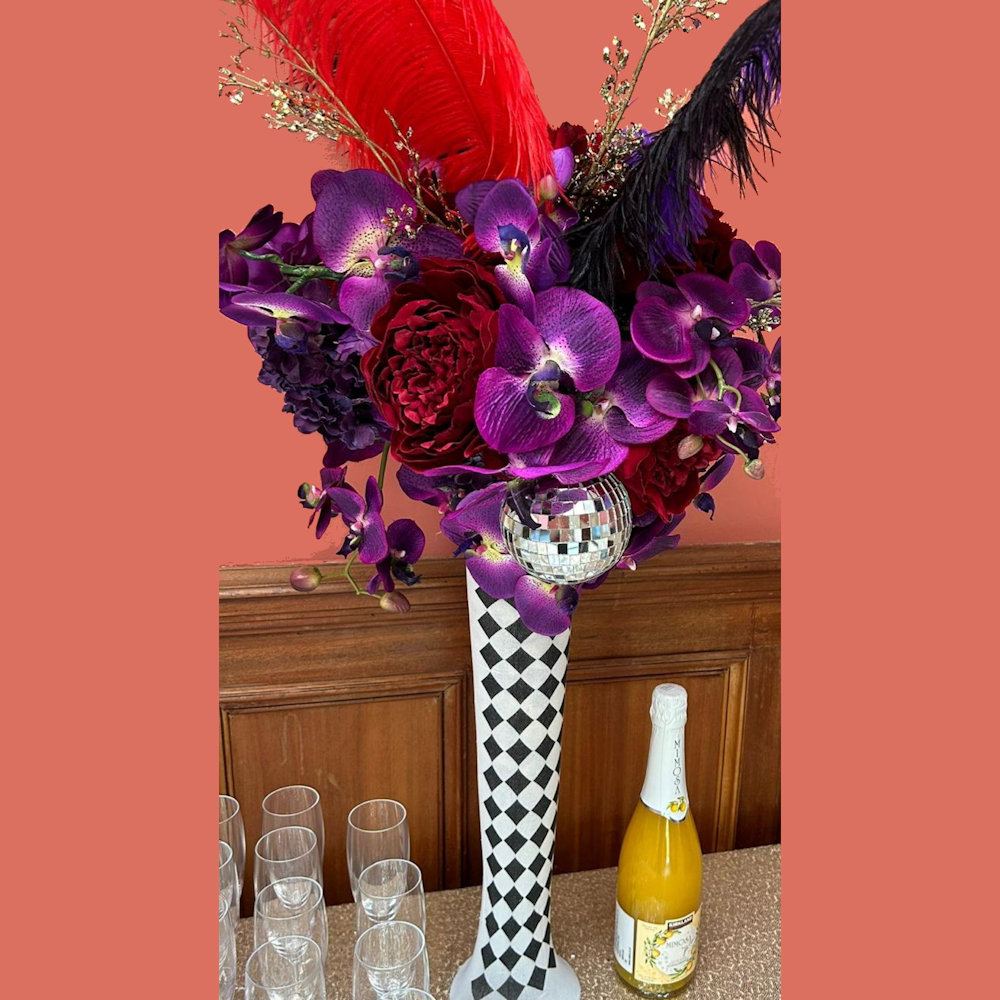 Circus Centrepiece Harlequin Vase with Purple & Red flowers feathers & mirror balls hire rent